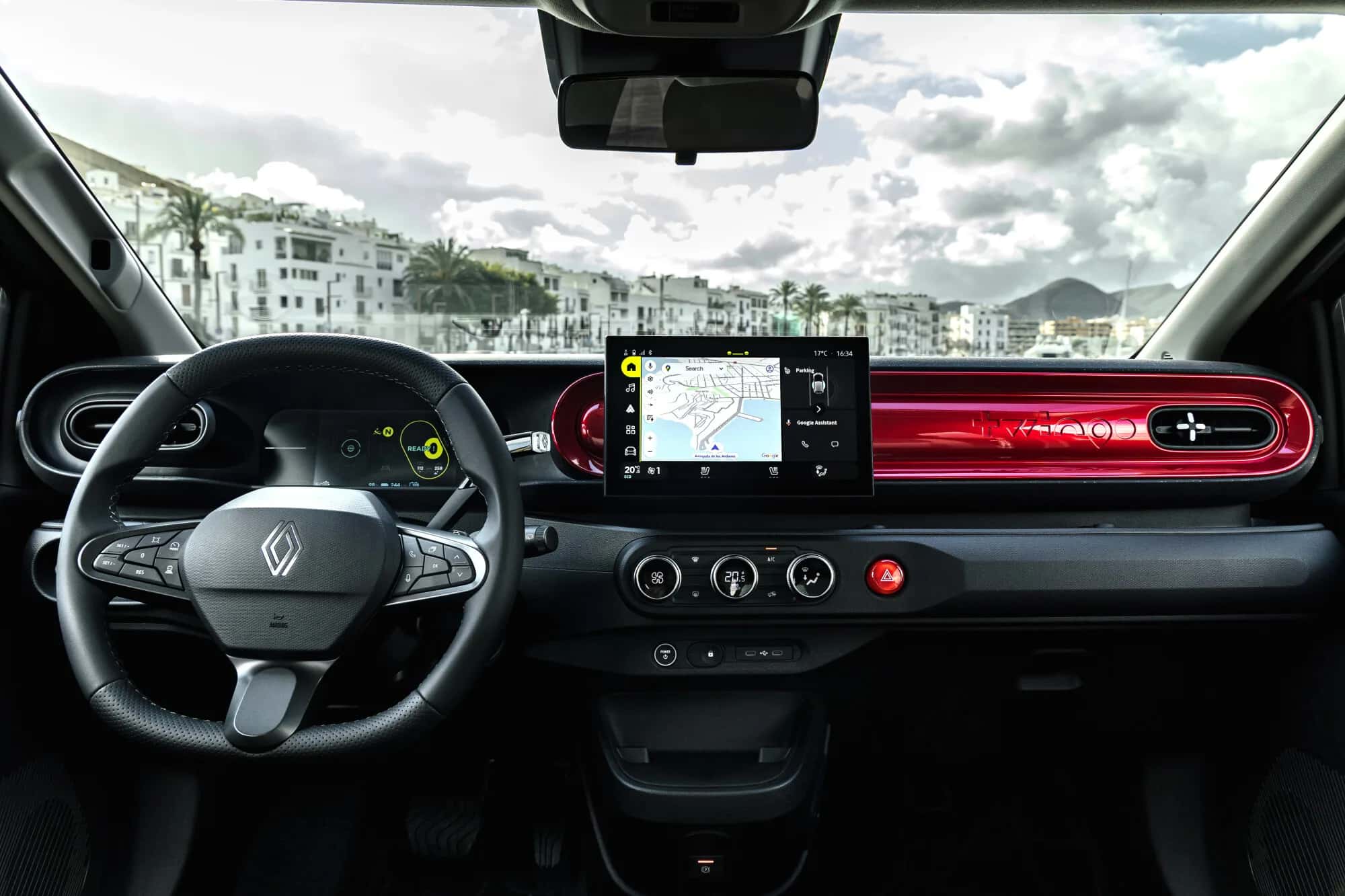 Cockpit de la Renault Twingo Techno 2026 : volant, écran central 10,1 pouces OpenR Link, planche de bord avec module cylindrique rouge et commandes physiques de climatisation