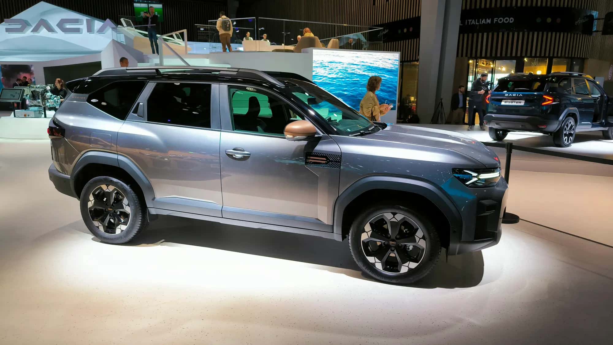 Le SUV Dacia Bigster gris-bleu vu de trois quarts avant sur un stand